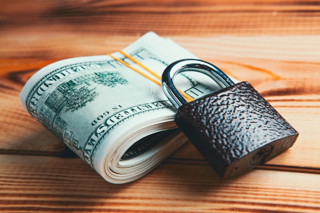 A smartphone screen showing a mobile money app with multiple clearly named savings goals and their growing balances.